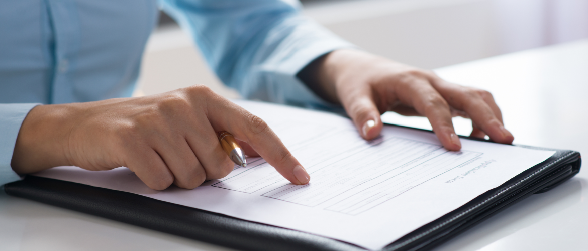 closeup-person-reading-studying-document 1